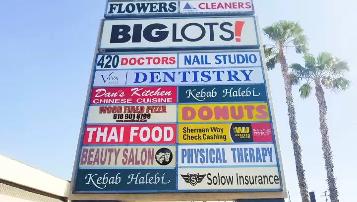 Outdoor pylon sign for industrial area plaza featuring logos of different businesses