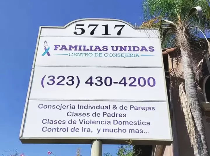 Pylon sign installed outdoors for Familias Unidas plaza featuring address and contact number