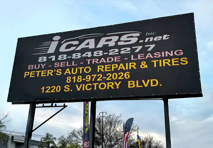 Pylon sign featuring the company logo and contact information on a black background