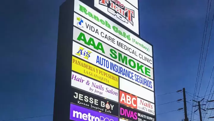 Pylon sign for commercial center showcasing various brand names