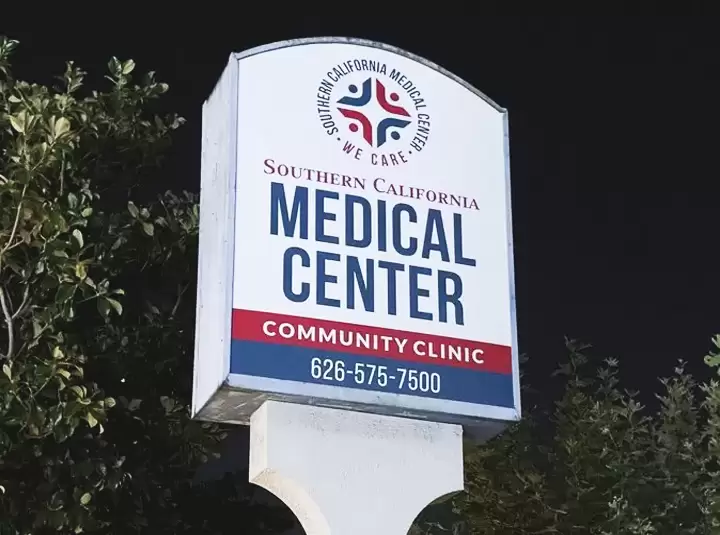 Pylon sign for Southern California Medical Center with logo and contact number in red and blue