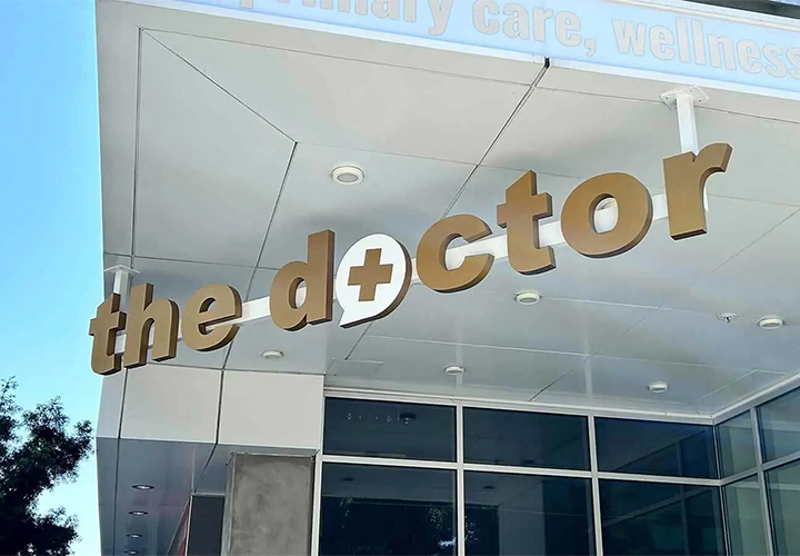 The Doctor foam core sign featuring the brand name and installed at the storefront