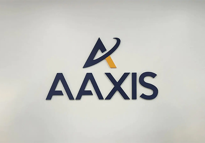 AAXIS reception sign installed on the wall and reading the brand name