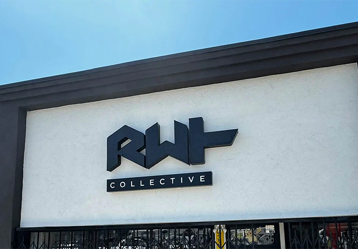 RWT Collective storefront sign on a building facade, reading the brand name made of aluminum