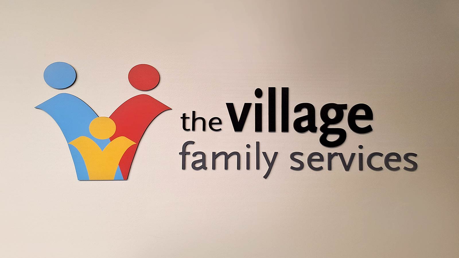the village family services wall sign mounted indoors