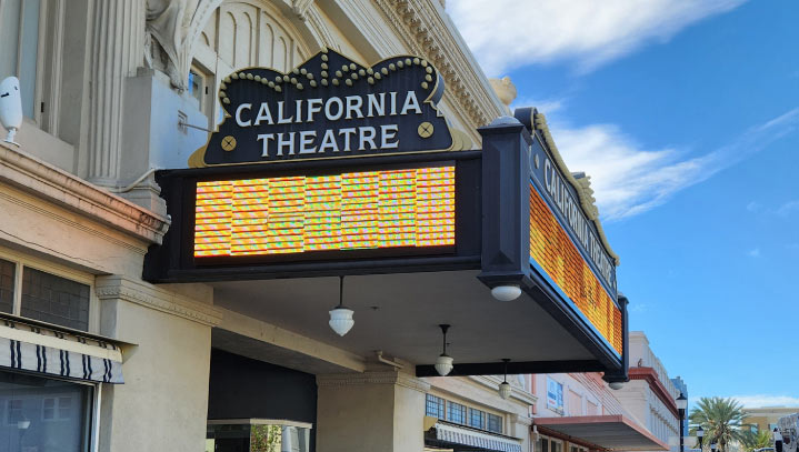 California Theatre LED display with a yellow screen and aluminum details on the facade