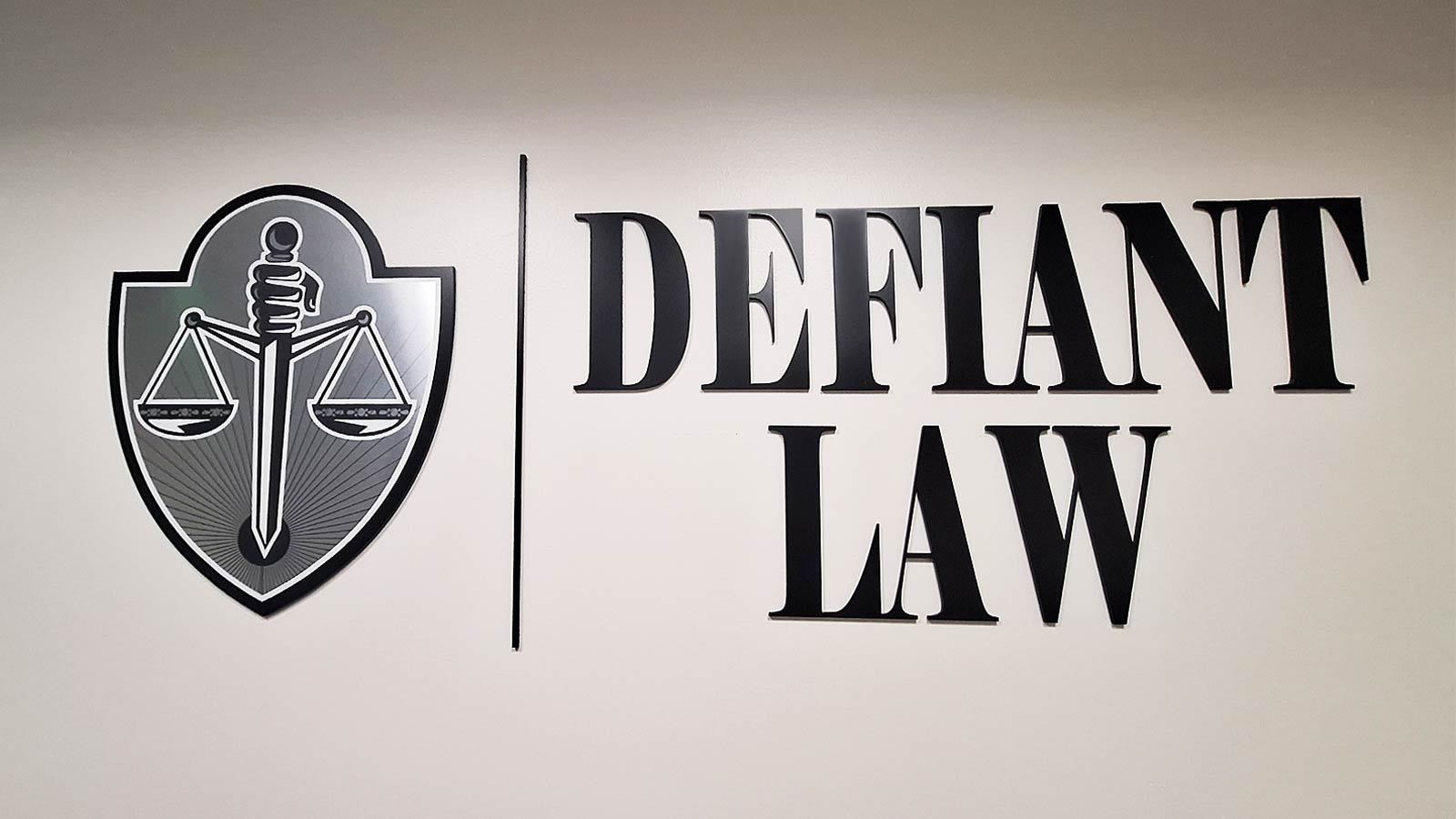 defiant law office sign attached to the indoor wall