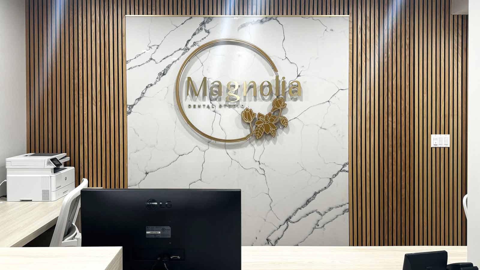 magnolia dental studio lobby sign attached to the wall