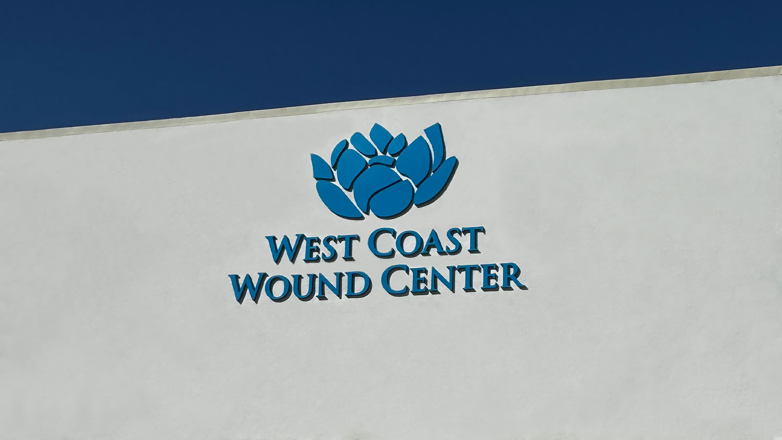 west coast wound center building sign installed on a facade