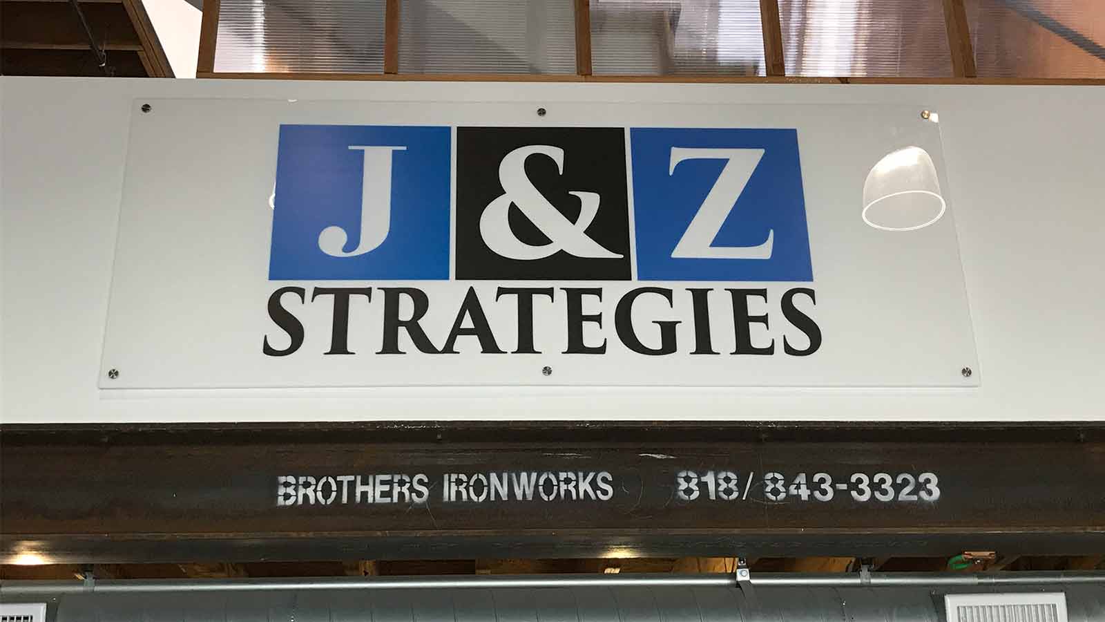 J & Z Strategies interior acrylic sign with standoffs