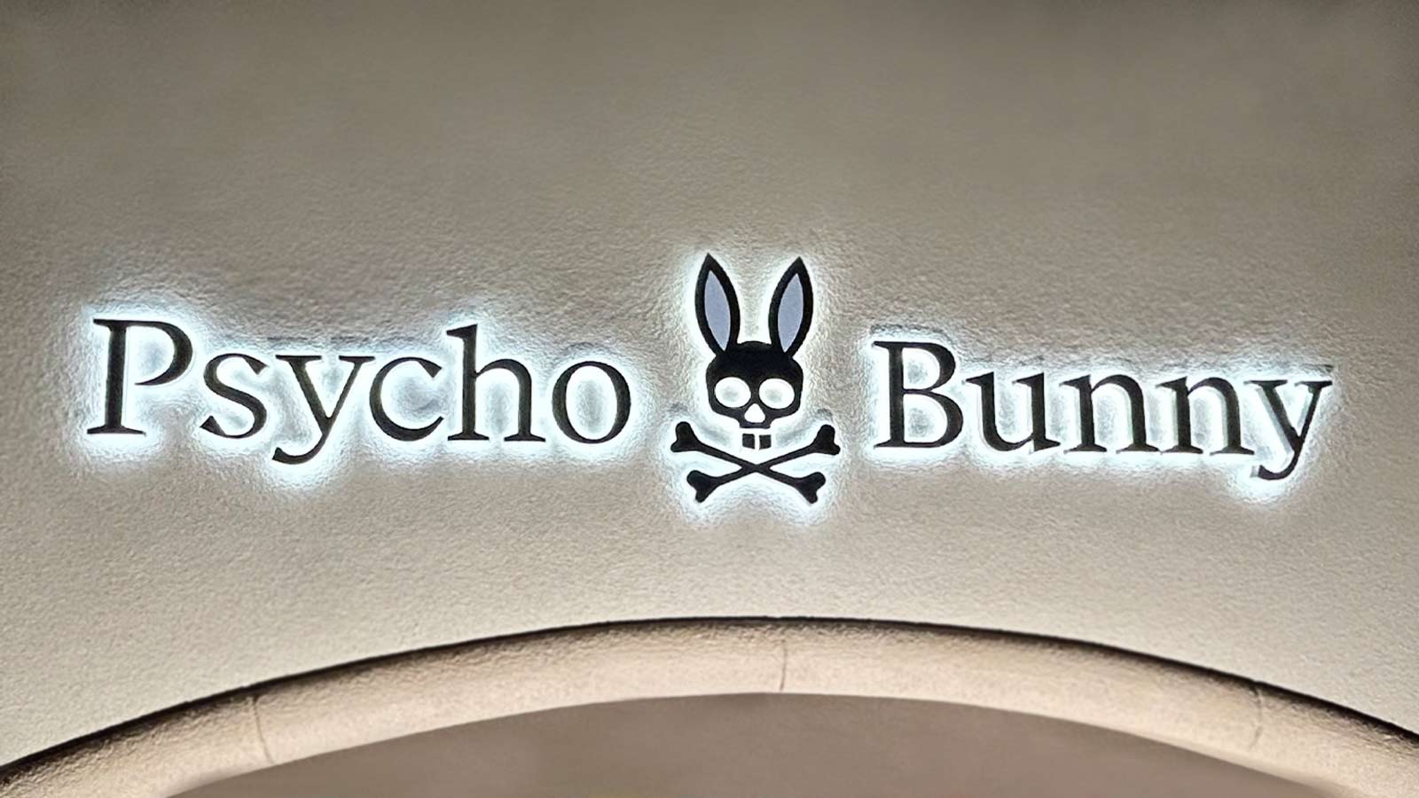 psycho bunny logo sign installation on the facade