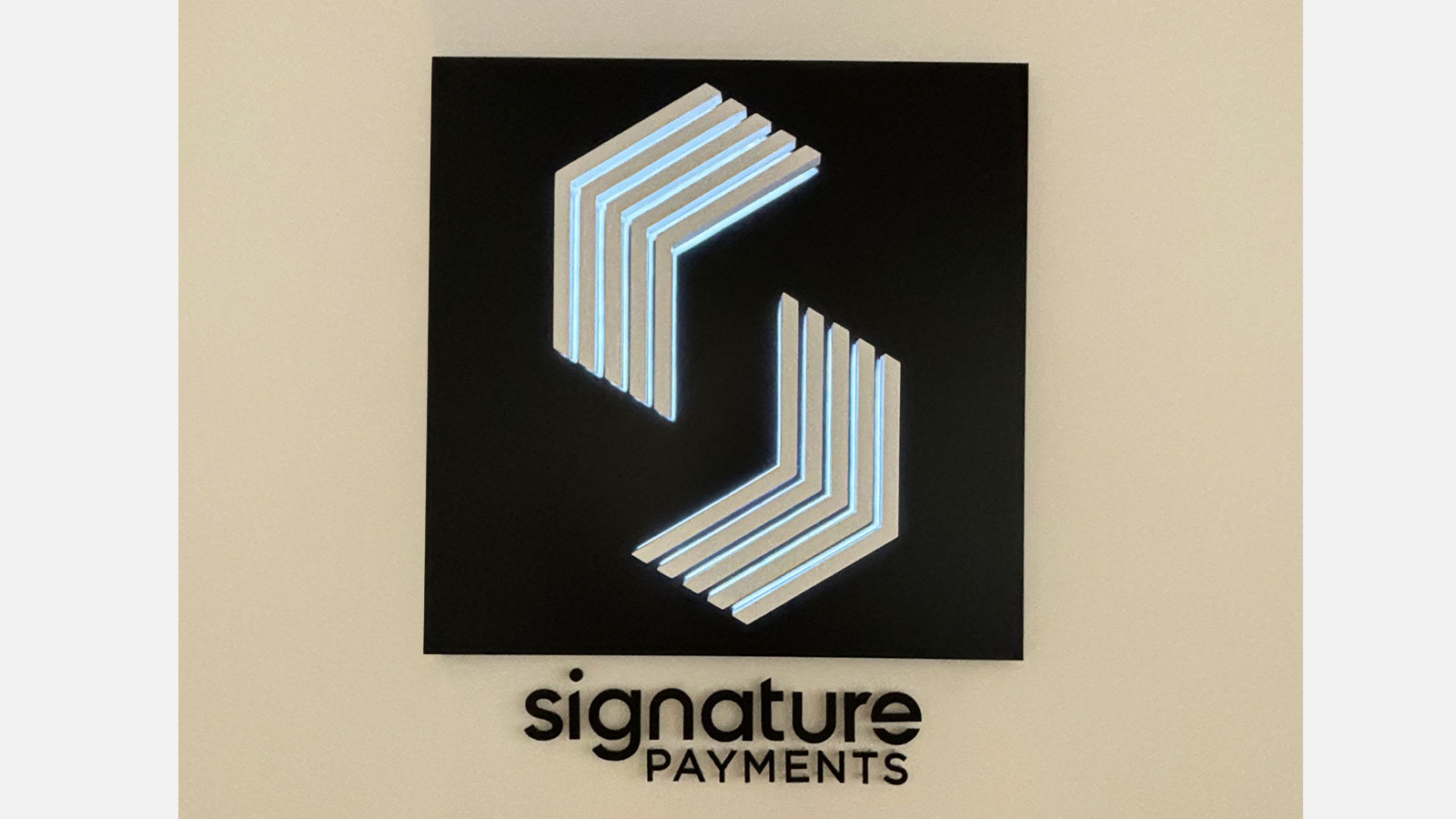 signature payments office signs attached to a wall