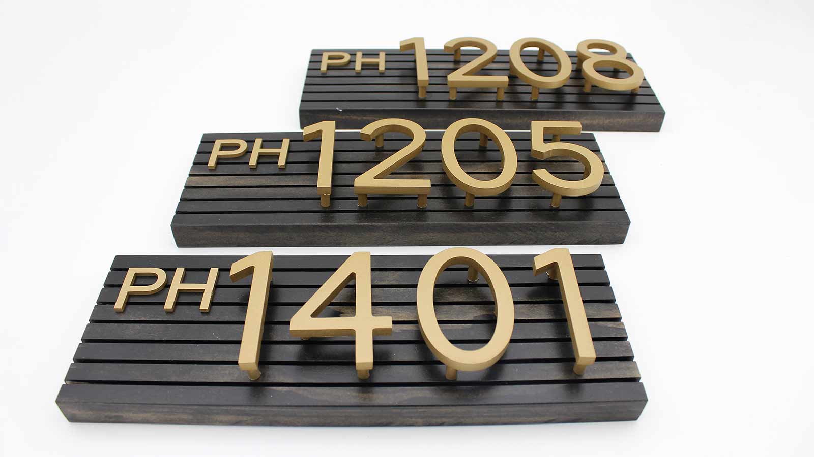 gold aluminum signs on wooden plaques