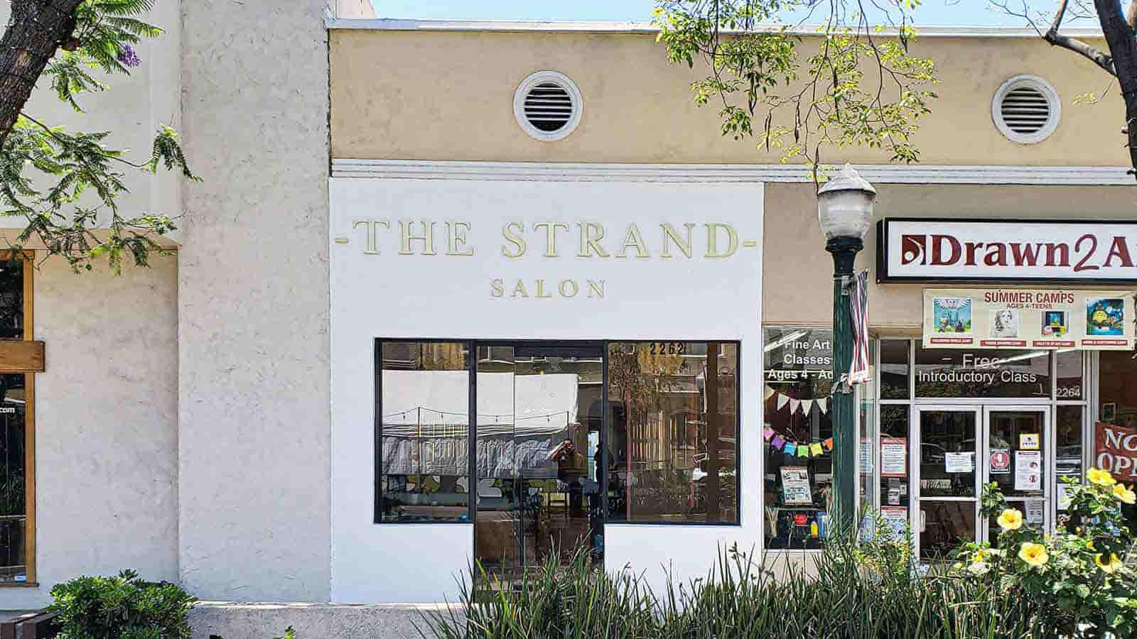 the strand salon building sign