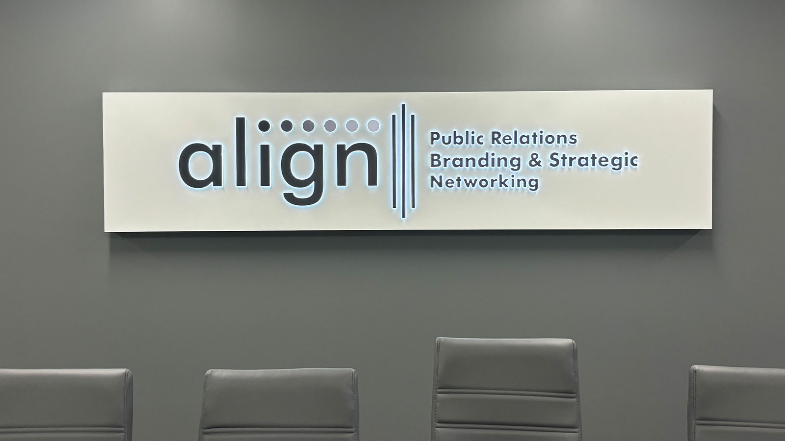 align pr push-through sign mounted on the wall