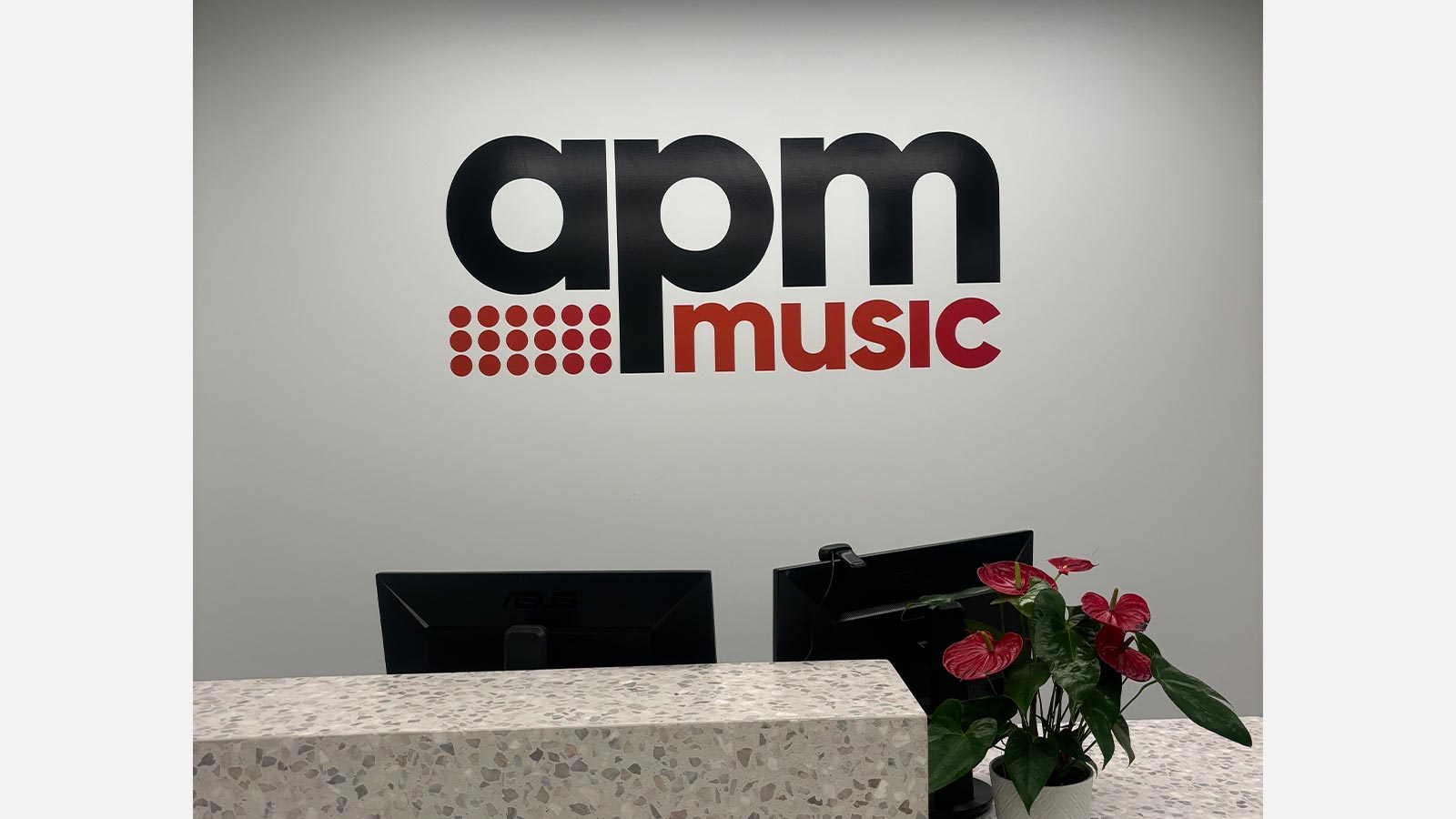 apm music black and red interior letters attached to a wall