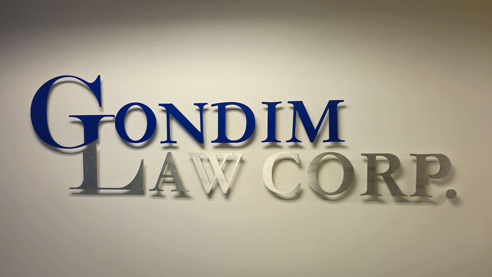 gondim law corp brushed aluminum letters on the wall