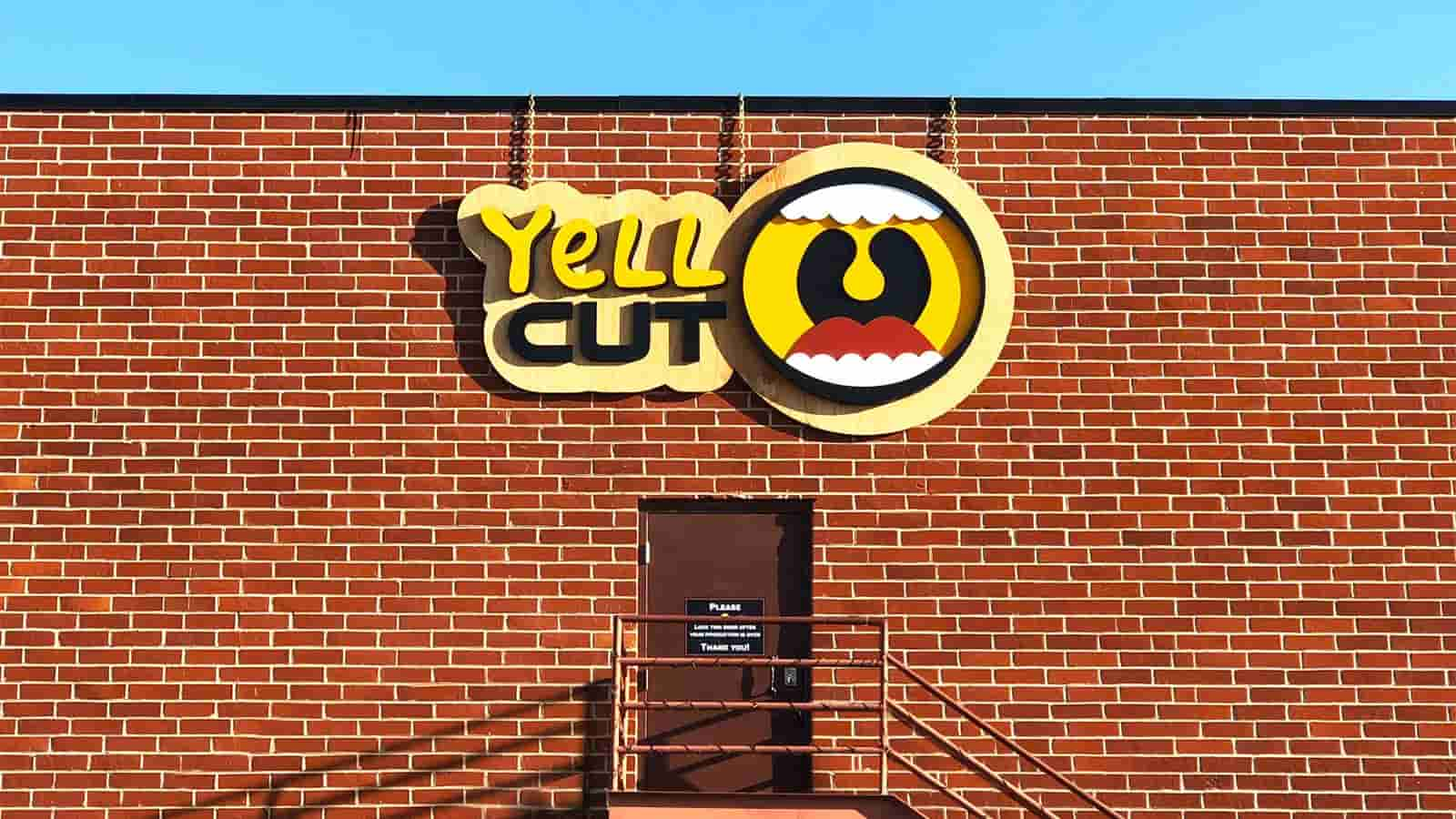 yell cut hanging wooden logo sign