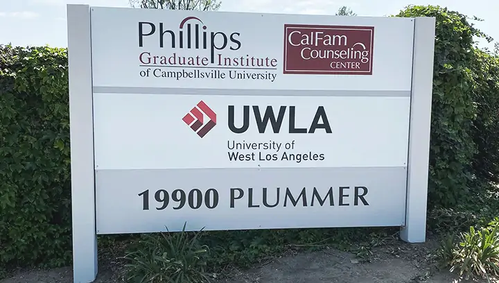 Outdoor signage featuring brand name and logo for University of West Los Angeles