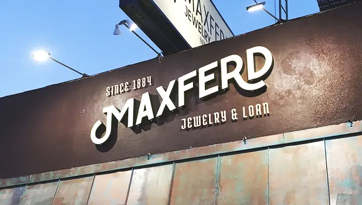 Custom outdoor signage displaying brand name for Maxferd in white on brown background