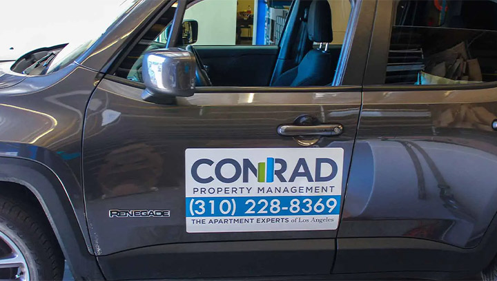 Car branding magnet for Conrad Property Management featuring the company logo and contact details