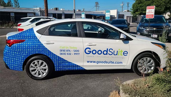 Partial car branding for GoodSuite with the brand logo and contact details in blue and lime green