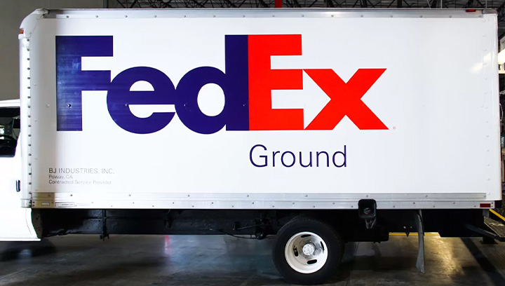 Vehicle branding for FedEx truck featuring bold lettering of brand name and logo