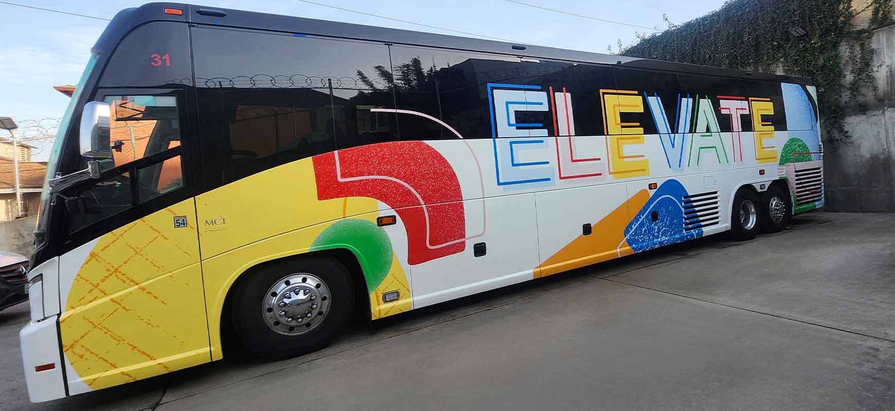 Vehicle branding for LAXCar reading Elevate in bright colors with abstract visuals